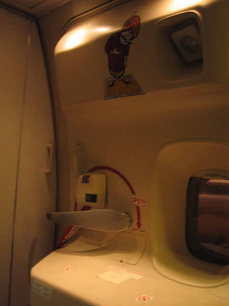 The India Air mascot wishing you a pleasant journey out the emergency exit at 35000 with no parachute. He, of course, has his magic carpet.